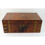 A Victorian walnut and brass bound campaign writing slope, the hinged lid enclosing a tooled leather