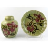 A Carlton Ware pottery ginger jar and cover with painted Iris decoration to a green ground