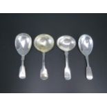 A collection of four assorted Fiddle pattern silver caddy spoons, various makers and dates, two