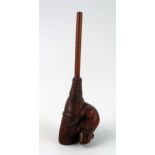 A Japanese carved boxwood netsuke of a rat on a broom, unsigned, 9cm long.