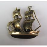 A Hallmarked 9ct Gold Charm Twin Mast Sailing Ship with cabochon garnet hull, 5.2g gross