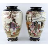 A large pair of Japanese vases of ovoid form, decorated with panels depicting figures in garden