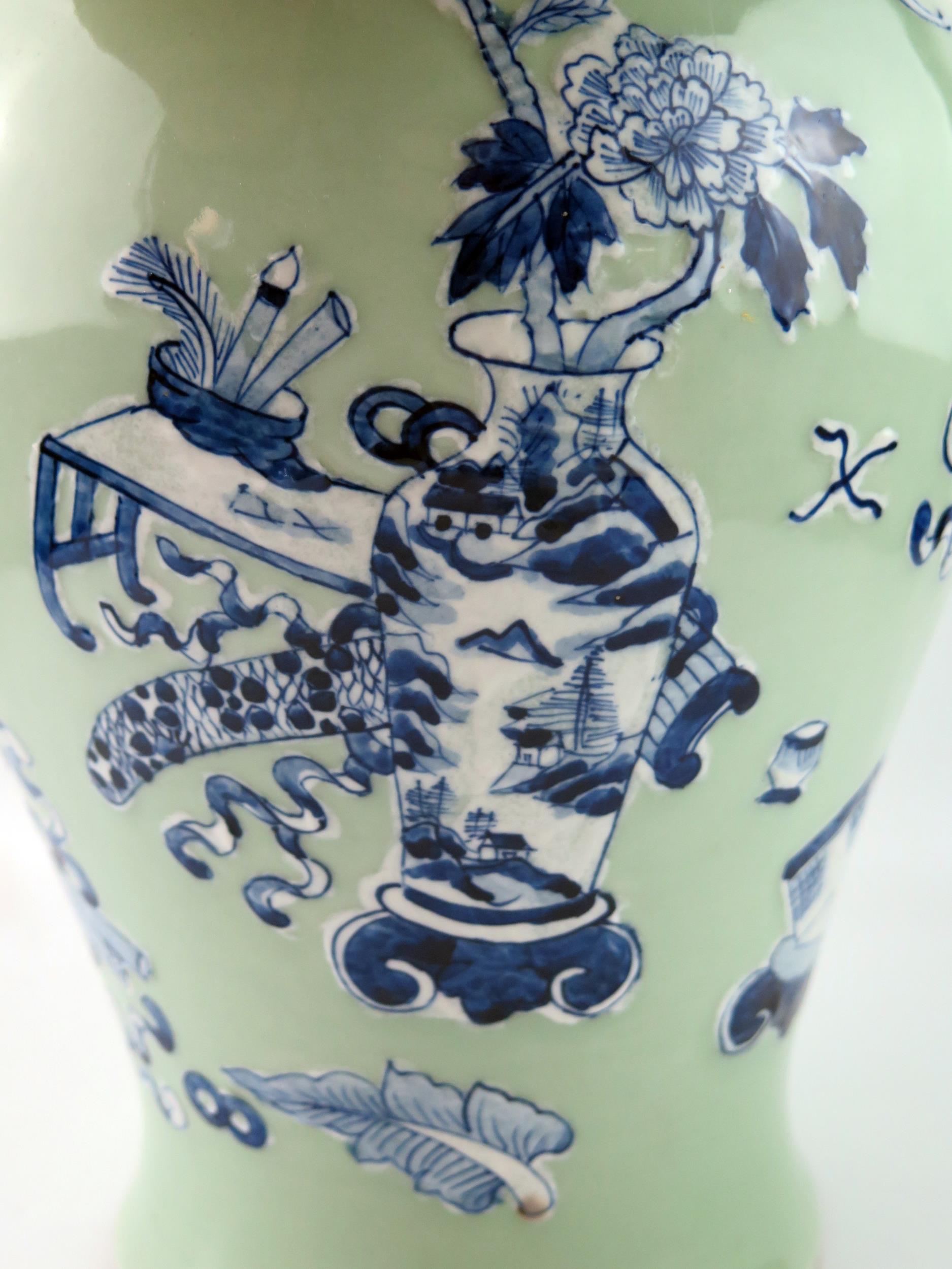 A Chinese vase of ovoid form, with blue and white auspicious objects to a green celadon ground, 37cm - Image 2 of 4