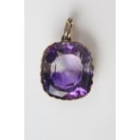 An Antique Amethyst Pendant in an unmarked gold setting, the 18.5x16.2mm stone with clear and purple