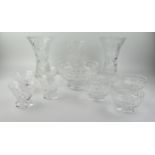 Three cut glass vases of waisted form, a fruit bowl and assorted sundae dishes.