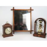 A reproduction four-glass mantel clock of arched outline, with 11cm silvered Roman dial, the single