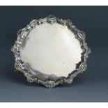 A George III silver waiter, maker I.C, London, 1772, with shell and scroll border, raised on three