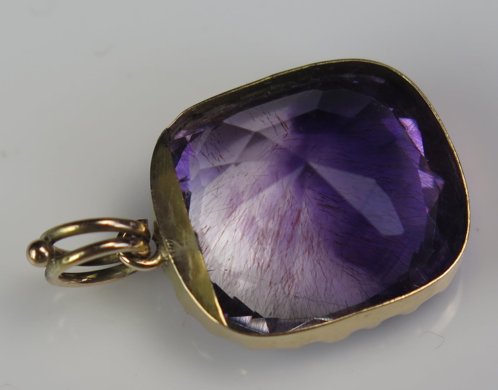 An Antique Amethyst Pendant in an unmarked gold setting, the 18.5x16.2mm stone with clear and purple - Image 6 of 6