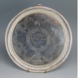 A Victorian silver waiter, makers mark indistinct, London, 1884, inscribed and dated, of circular