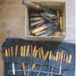 A collection of assorted wood carving chisels and files.