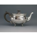 An Edward VII silver barge-shaped teapot, maker Elkington & Co, Birmingham, 1908, monogrammed, on