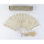 An Edwardian fan with lace work leaf mounted on mother-of-pearl sticks and guards, 19cm long.