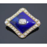 An Old Cut Diamond Brooch with a royal blue enamel surround with untested pearl set edges and in