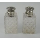 A pair of Victorian clear glass and silver mounted scent bottles, maker Charles Asprey & Charles