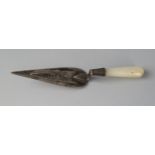 A silver book mark in the form of a trowel, with mother-of-pearl handle, 7cm long.