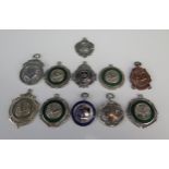 A collection of silver and silver plated fobs and sporting medallions, various makers and dates.