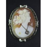 A 14K White Gold Mounted Shell Cameo Brooch with hinged pendant suspension loop, decorated with