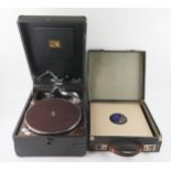An HMV portable wind-up gramophone and selection of 79RPM records