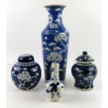 A Chinese blue and white vase with all over prunus decoration, 30cm high, a small bottle vase,