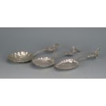 Three Dutch silver spoons, stamped marks, the bowls decorated with figures in village scenes, having