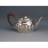 A Victorian silver oval teapot, maker Charles Stuart Harris, London, 1889 with lobed decoration,