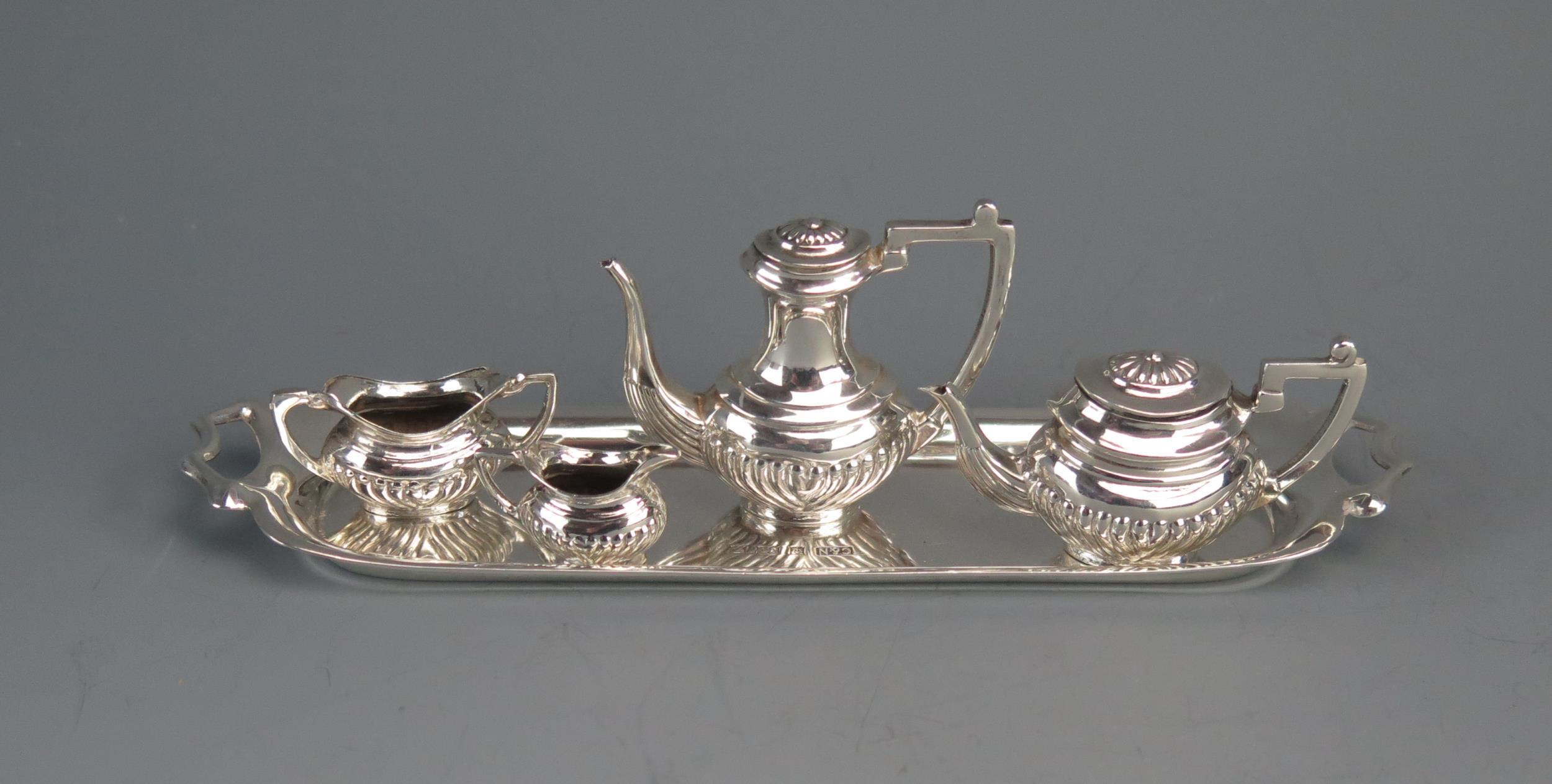 An Elizabeth II miniature four-piece silver tea service, maker Crisford & Norris Ltd, Birmingham,