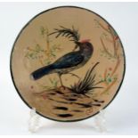 A Diaz Costa pottery plate, decorated with an exotic bird amongst shrubs, monogrammed CD, 21cm