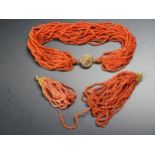 An Antique Multi Strand Coral Necklace with yellow metal clasp and pair of similar earrings with