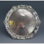 A George III silver waiter, all marks worn and illegible, of circular outline, with shell and scroll