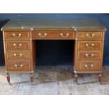 A reproduction mahogany and brass knee hole desk of rectangular outline the inverted breakfront with