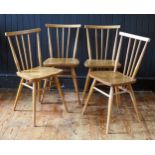 A set of four 1950's Ercol blonde stick-back chairs, with solid seats and turned legs.