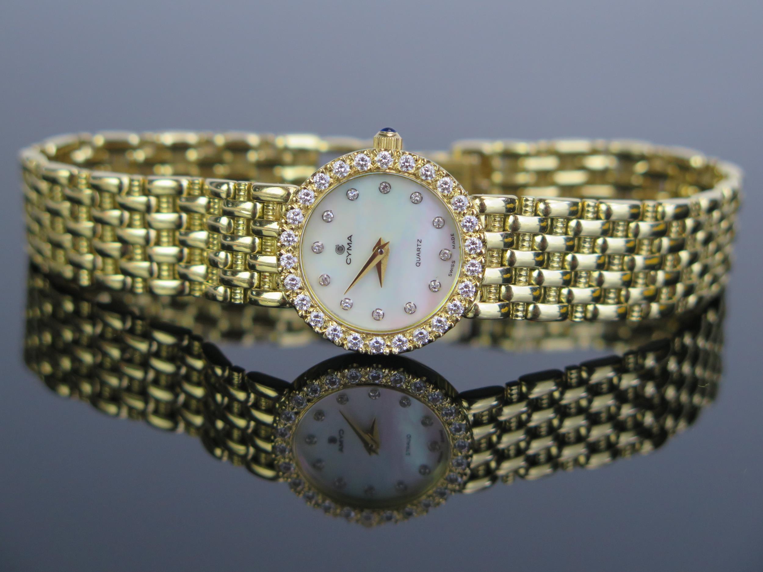 A CYMA Ladies 18ct Gold Wristwatch with diamond set bezel and mother of 20mm pearl dial with further