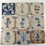 Nine assorted Dutch Delft tiles each decorated with a flower or floral sprays, each 13 x 13cm.