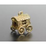 A Hallmarked 9ct Gold Charm Gypsy Caravan with hinged top opening to reveal an enameled fortune