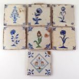 Seven Dutch Delft blue and white tiles depicting flowers and floral sprays,