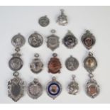 A collection of assorted silver and plated sports medallions, St. Christopher's and other fobs,
