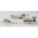 A Chinese silver model of a harbourside crane and cabin, , a two wheeled cart and and an eastern