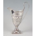 A George III silver cream jug, maker Charles Hougham, London, 1784, of helmet-shaped outline, with
