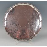 A George III silver circular salver , makers mark worn, London, 1762, with beaded rim, having chased