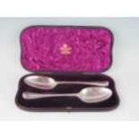 A pair of Georgian silver Hanoverian pattern tablespoons, marks worn London, crested and