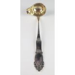 A large continental silver soup ladle, having an oval lipped bowl with gilded interior, 35cm long,