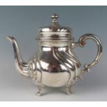 A German silver circular teapot, stamped marks, of ovoid writhen form, with scroll handle, and