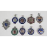 A collection of nine silver and enamel medallions/fobs, various makers and dates mostly related to