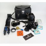 An Olympus OM10 35mm camera, with three spare lenses, tripod and carrying case.