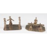 Two miniature silver figure groups, three dancing ladies on a rectangular base, and a cabinet