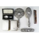 A collection of assorted silver backed dressing table wares, includes hand mirror, comb, clothes