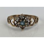 A Modern 9ct Gold Flower Head Cluster Ring with blue tourmaline? and white stones, hallmarked,