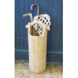 An African carved hard wood water pail, two walking sticks and a cane carpet beater.