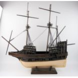 A wooden model of a two mast galleon, with painted hull, eight cannons, partially rigged, 72cm long.