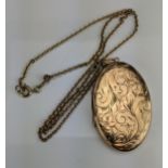 A Large 9ct Gold Oval Locket with chased foliate decoration, c. 45x29mm and on a 9ct gold chain (